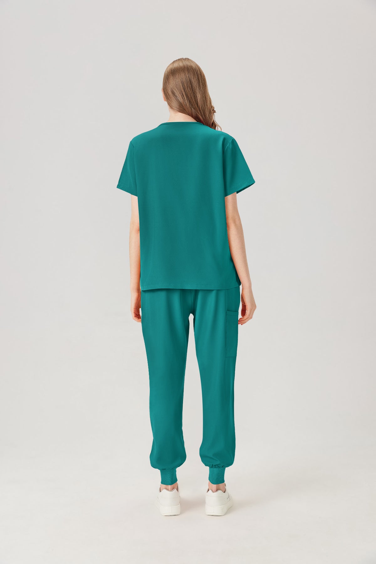 Uniforme médico femenino verde esmeralda, vista posterior