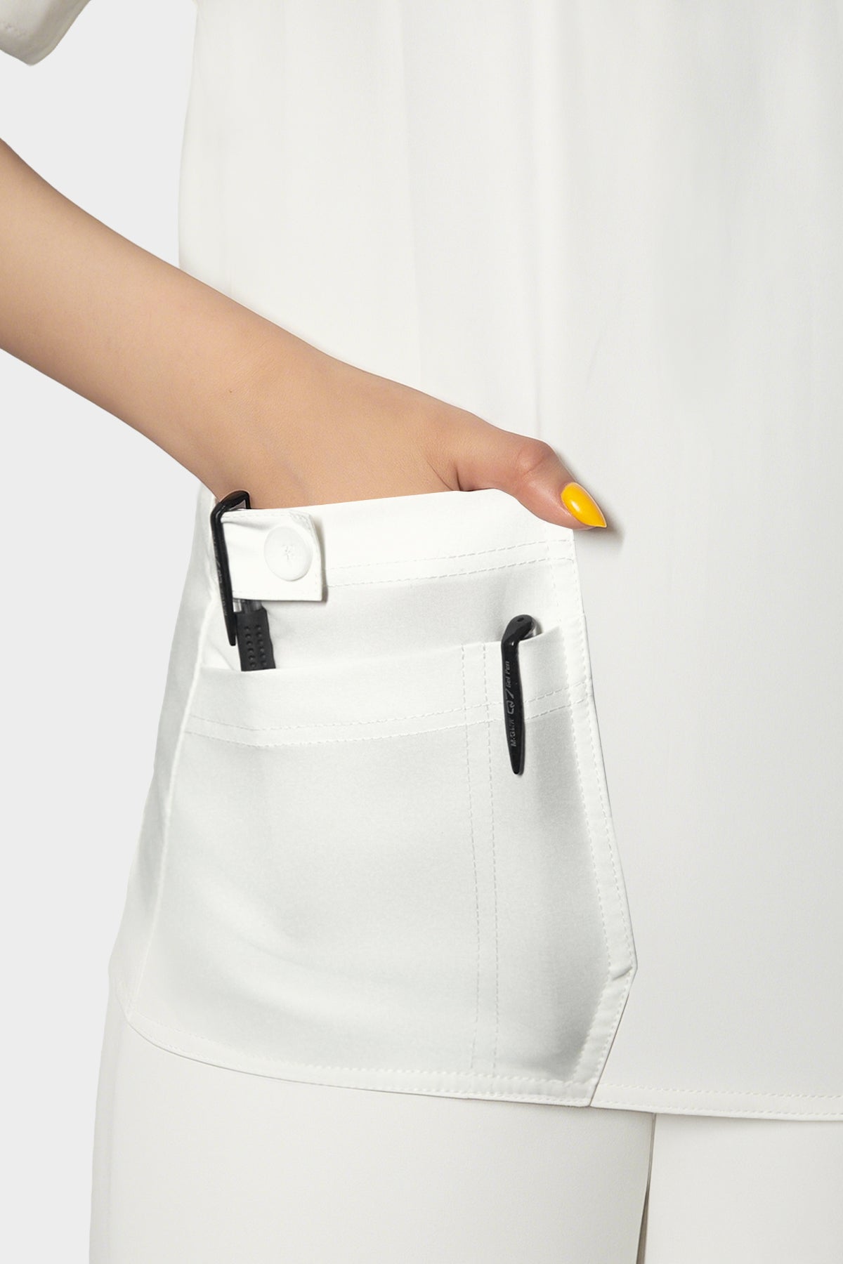 Uniforme médico blanco de mujer con bolsillos grandes.